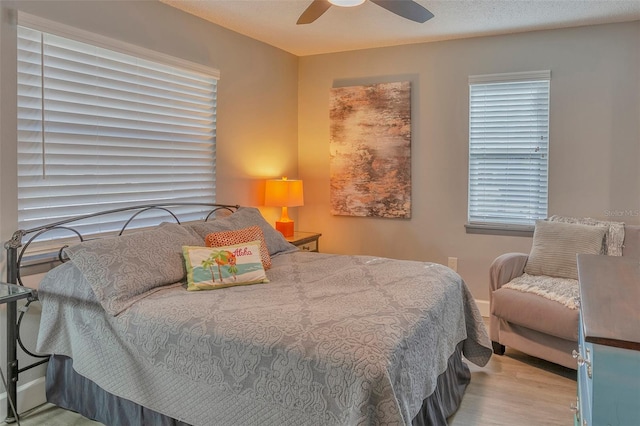 bedroom with ceiling fan and hardwood / wood-style flooring