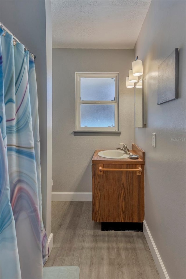 bathroom featuring hardwood / wood-style flooring, a textured ceiling, and vanity