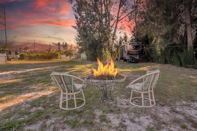 1478 Alternate Keene Rd, Largo, FL 33771 - yard at dusk with an outdoor fire pit