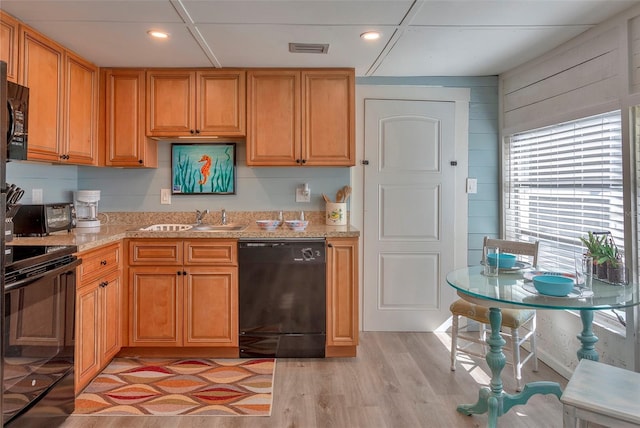 1478 Alternate Keene Rd, Largo, FL 33771 - kitchen featuring a sink, visible vents, light stone countertops, and black appliances