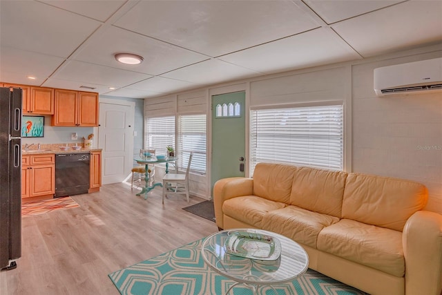 living room featuring light wood-type flooring, a paneled ceiling, a wall unit AC, and wet bar