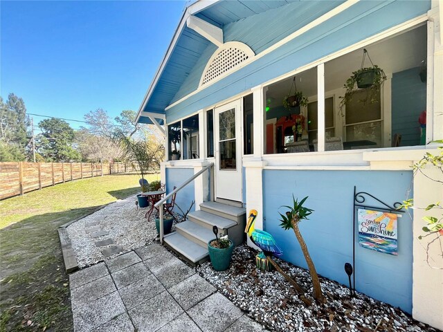 1478 Alternate Keene Rd, Largo, FL 33771 - view of patio with a sunroom, fence, and entry steps
