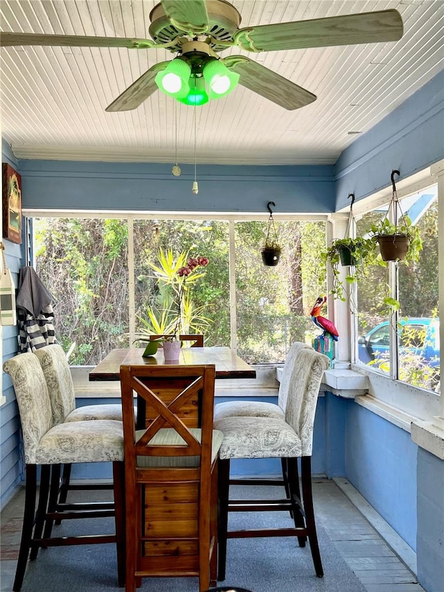 sunroom featuring ceiling fan