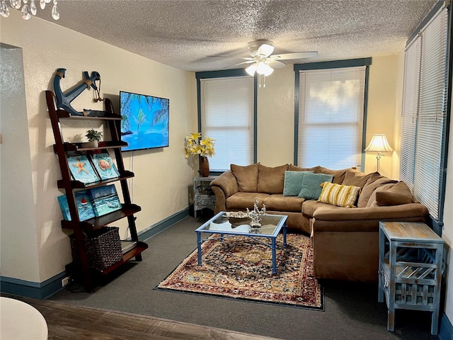 living room featuring ceiling fan, hardwood / wood-style flooring, and a textured ceiling