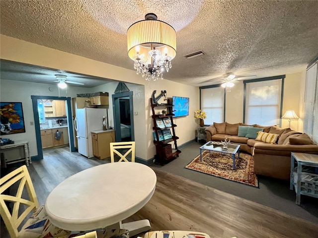 1478 Alternate Keene Rd, Largo, FL 33771 - living room with light wood-type flooring, visible vents, a textured ceiling, and ceiling fan