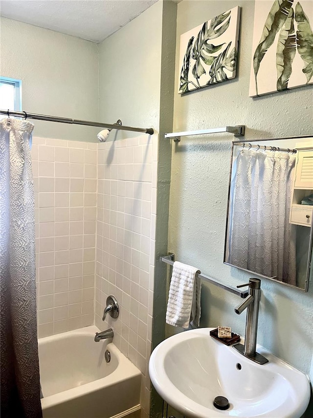 1478 Alternate Keene Rd, Largo, FL 33771 - bathroom with a textured wall, shower / tub combo with curtain, and a sink