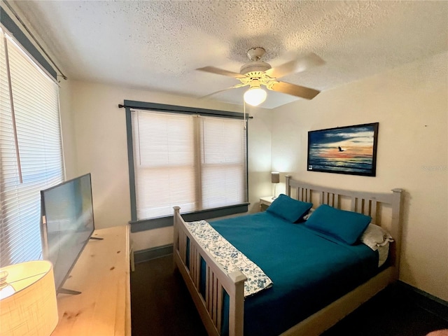 bedroom featuring a textured ceiling and ceiling fan