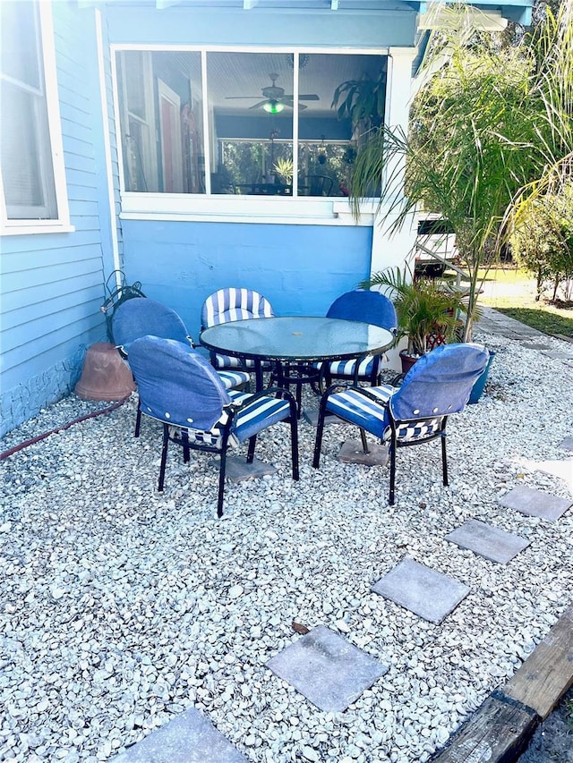 1478 Alternate Keene Rd, Largo, FL 33771 - view of patio featuring a sunroom and outdoor dining space