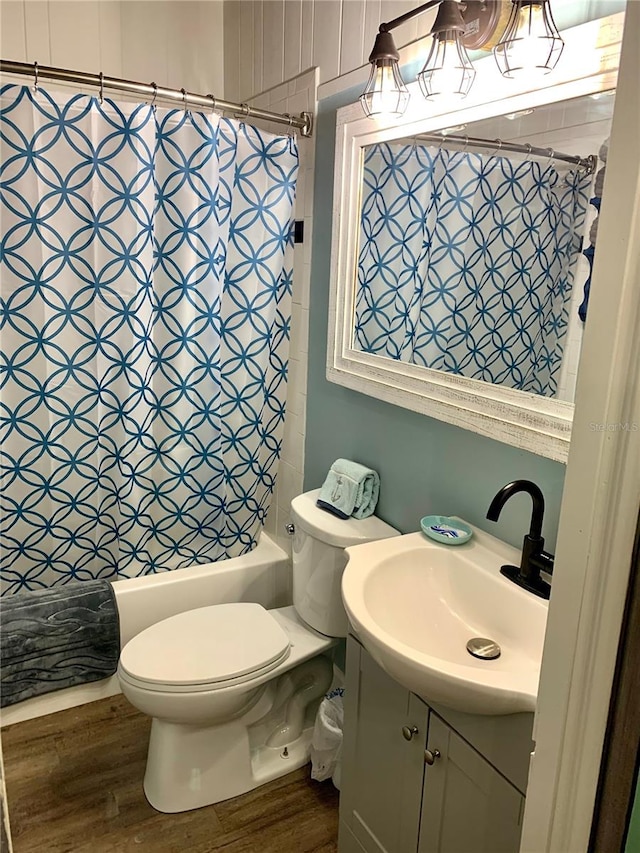 full bathroom featuring vanity, toilet, wood-type flooring, and shower / tub combo