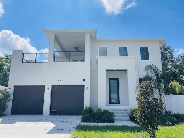 contemporary house with a garage and a balcony