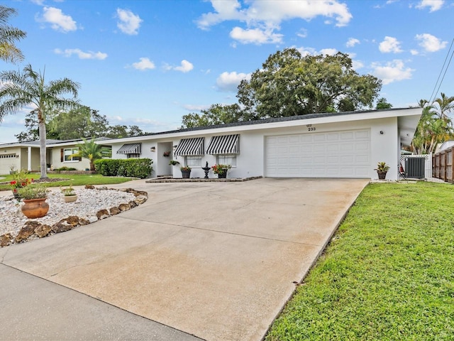 ranch-style home with a garage and a front yard