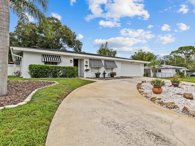 ranch-style house with a front yard and a garage