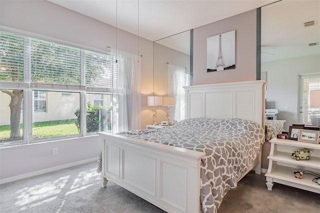 carpeted bedroom featuring multiple windows