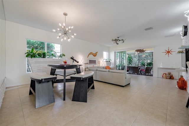 tiled dining space with a wealth of natural light and a chandelier