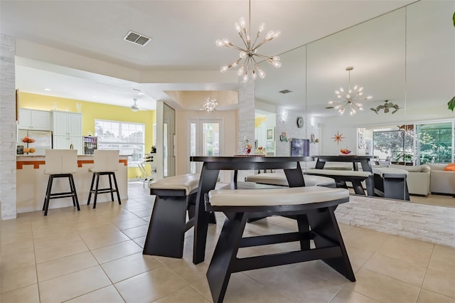 dining space featuring plenty of natural light, a notable chandelier, and light tile patterned floors