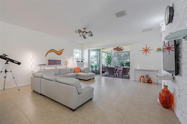 living room with a fireplace and light tile patterned floors