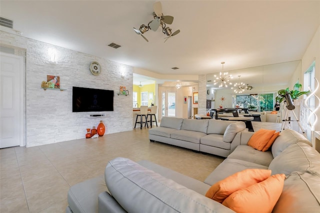 living room with light tile patterned floors and a chandelier