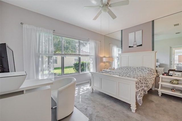 bedroom with ceiling fan and light carpet