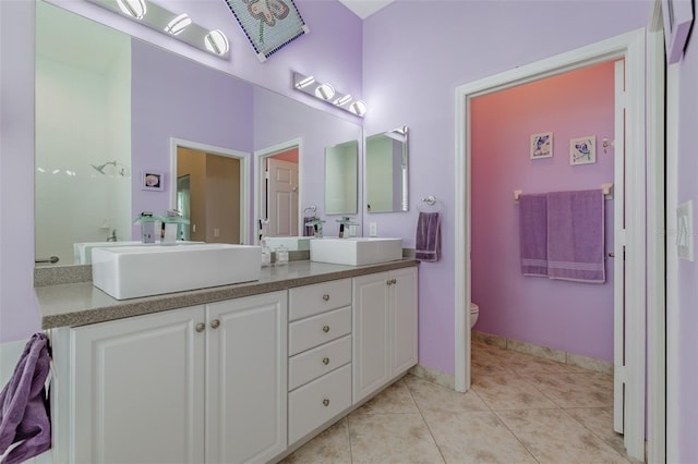 bathroom featuring vanity, toilet, tile patterned floors, and walk in shower