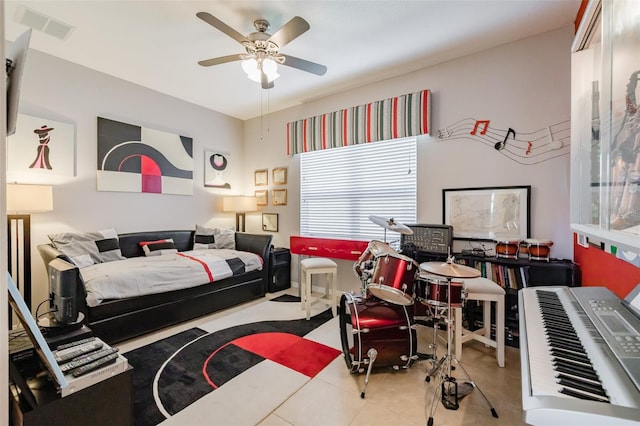 tiled bedroom featuring ceiling fan