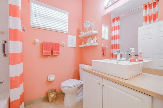 bathroom with vanity, toilet, curtained shower, and tile patterned floors