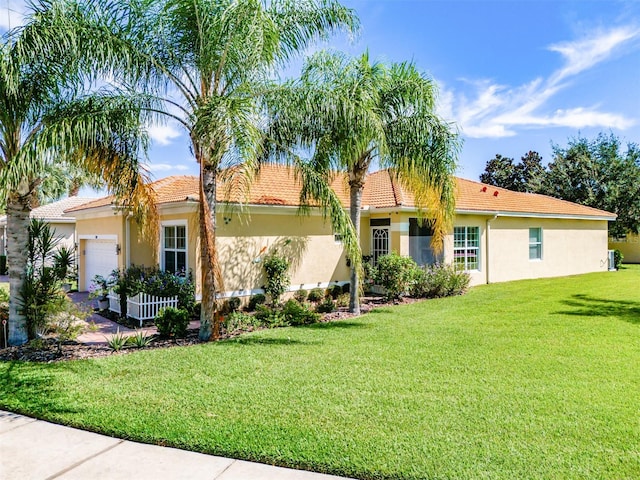 view of front of property featuring a garage and a front yard