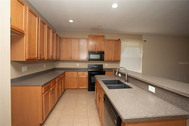 kitchen featuring black appliances, light tile patterned floors, and sink