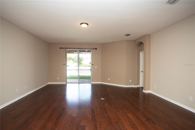 empty room featuring dark hardwood / wood-style flooring