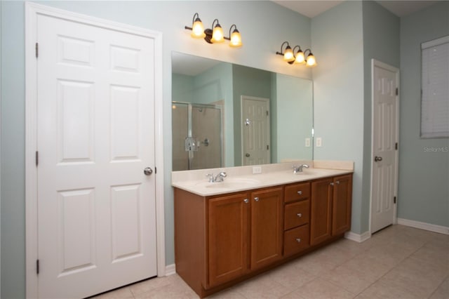 bathroom featuring tile patterned floors, a shower with shower door, and vanity