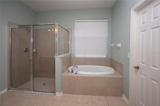 bathroom with independent shower and bath and tile patterned flooring