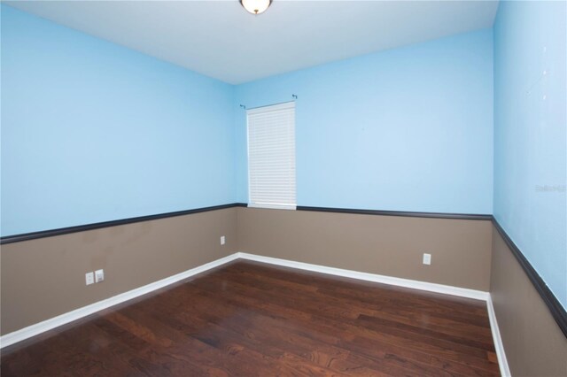 unfurnished room with hardwood / wood-style flooring