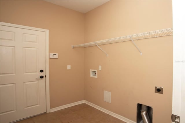 clothes washing area featuring hookup for a washing machine, hookup for an electric dryer, and tile patterned floors