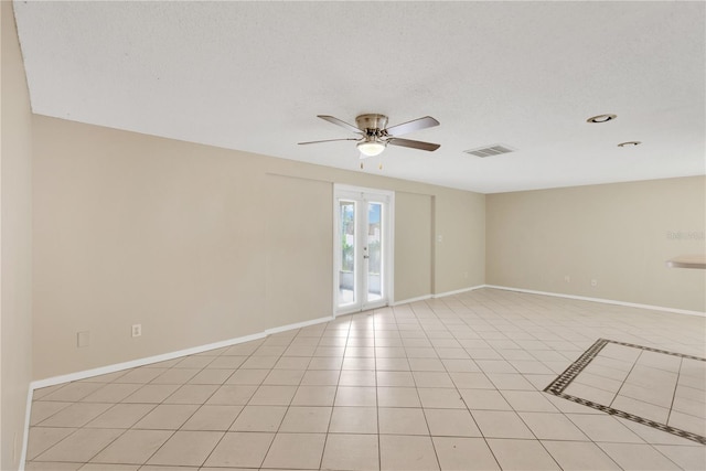 unfurnished room with ceiling fan, light tile patterned floors, a textured ceiling, and french doors