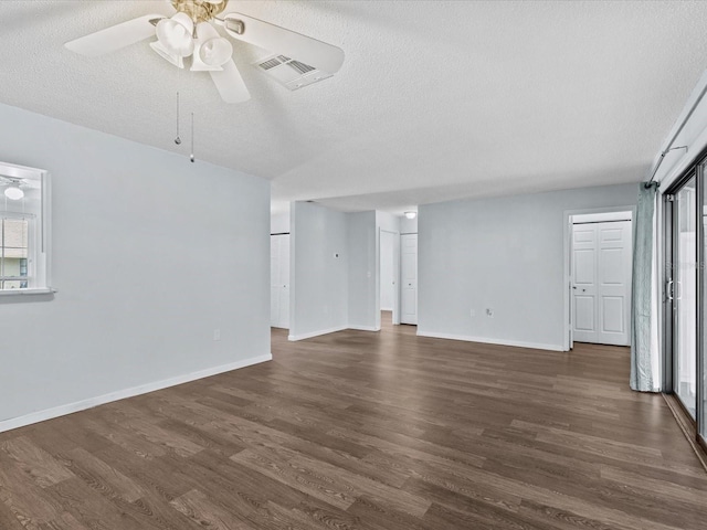 interior space featuring a textured ceiling, dark wood-type flooring, and ceiling fan