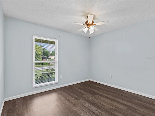 spare room with dark hardwood / wood-style flooring, ceiling fan, and a textured ceiling