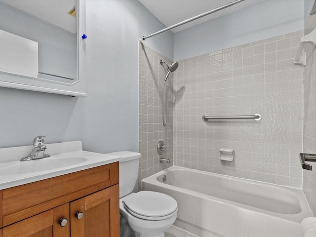 full bathroom with toilet, tiled shower / bath combo, and vanity