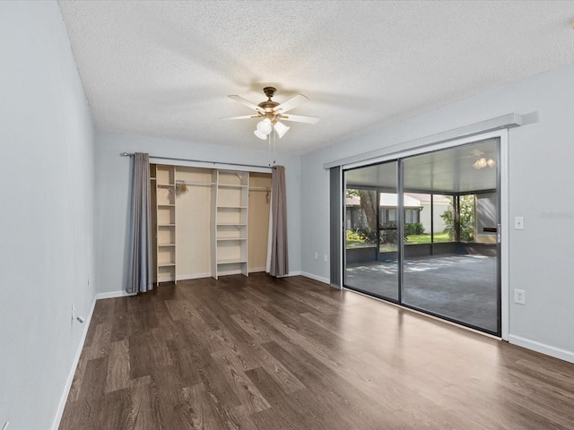 unfurnished bedroom with a textured ceiling, access to outside, ceiling fan, and dark hardwood / wood-style floors