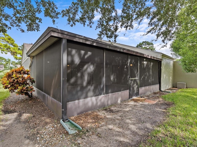 view of home's exterior with a sunroom