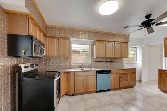 kitchen featuring appliances with stainless steel finishes, decorative backsplash, sink, and ceiling fan