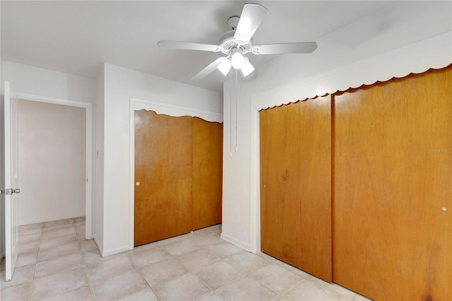 unfurnished bedroom featuring ceiling fan and a closet