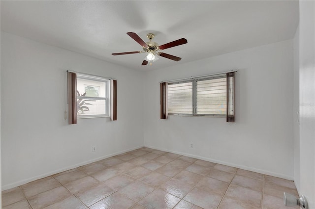 tiled spare room featuring ceiling fan