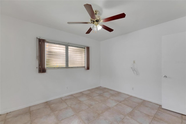 unfurnished room with ceiling fan and light tile patterned floors