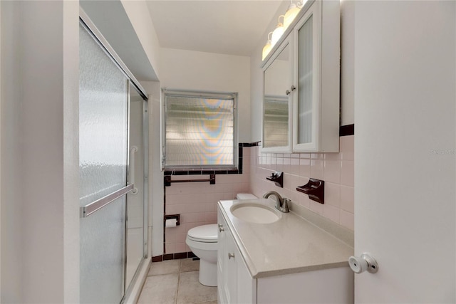 bathroom with walk in shower, vanity, tile patterned flooring, and toilet