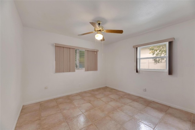 spare room featuring light tile patterned flooring and ceiling fan