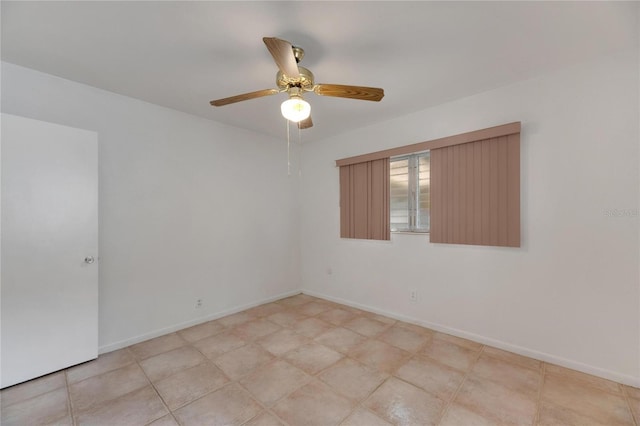 tiled spare room featuring ceiling fan