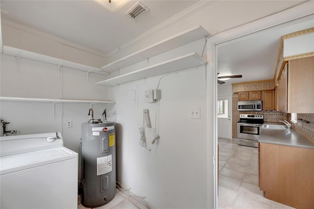 utility room featuring water heater, washer / clothes dryer, and sink