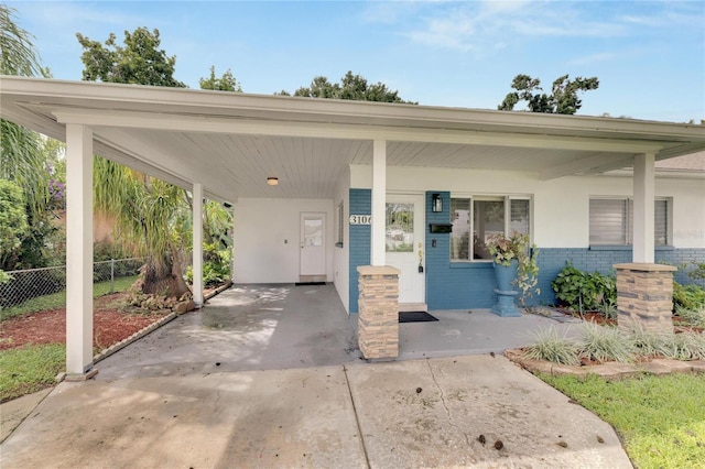 view of front of house featuring covered porch and a carport