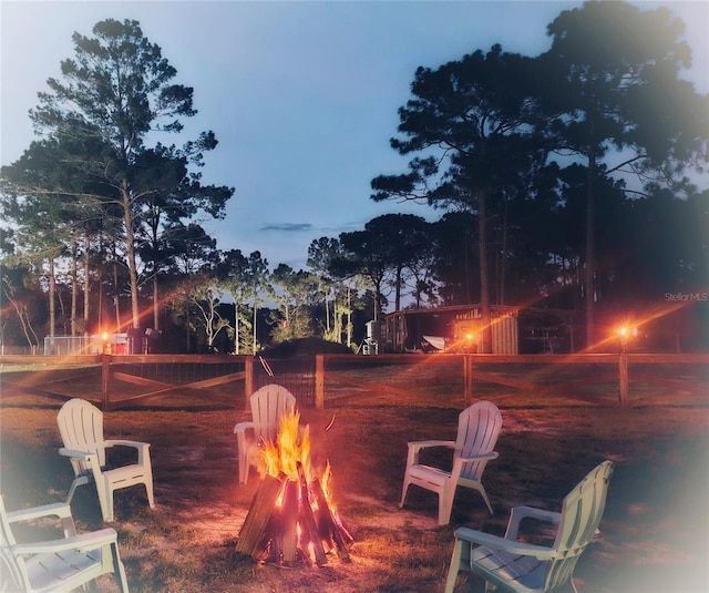 yard at dusk with a fire pit