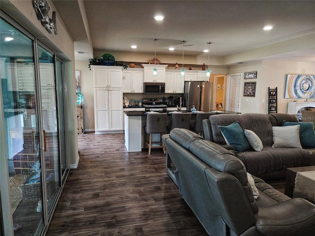 living room featuring sink and dark hardwood / wood-style flooring