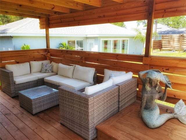 wooden terrace with an outdoor living space